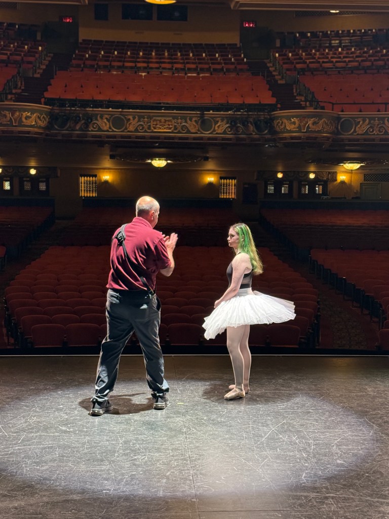 Dave Dabour Photography discusses a pose with one of his dance ambassadors at the State Theatre