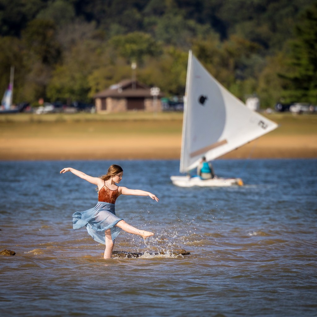 Ballerina Vivi Taggart performing a graceful pose outdoors in a body of water