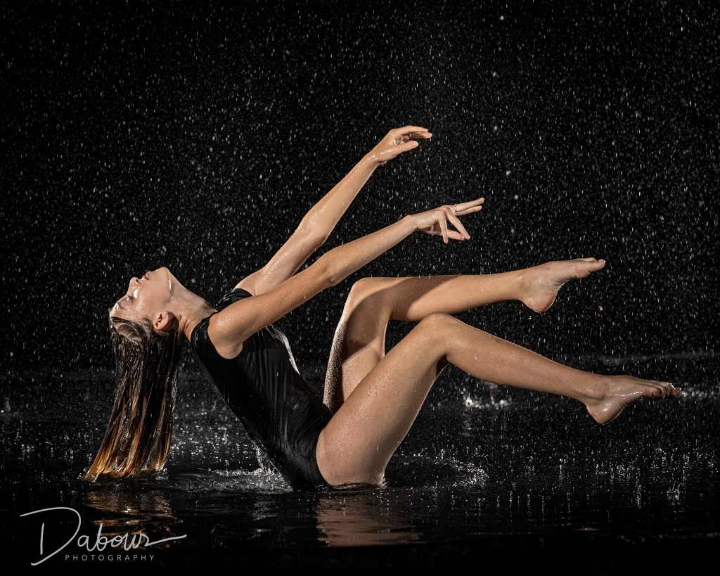 Dance ambassador Ellery performing a leap in a rain machine at Dabour Photography studio