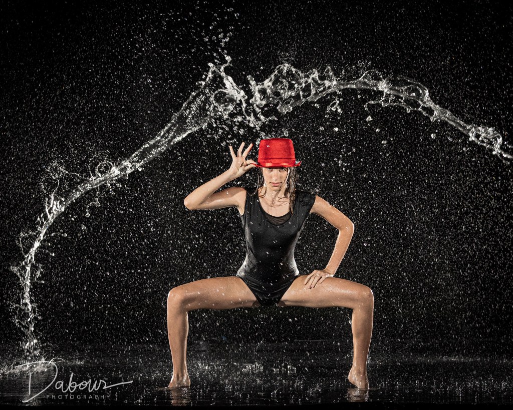Dance ambassador Ellery performing a leap in a rain machine at Dabour Photography studio